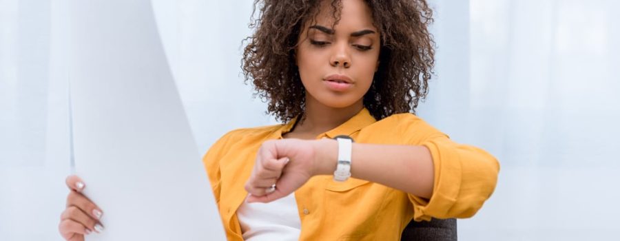 young woman looking at her watch