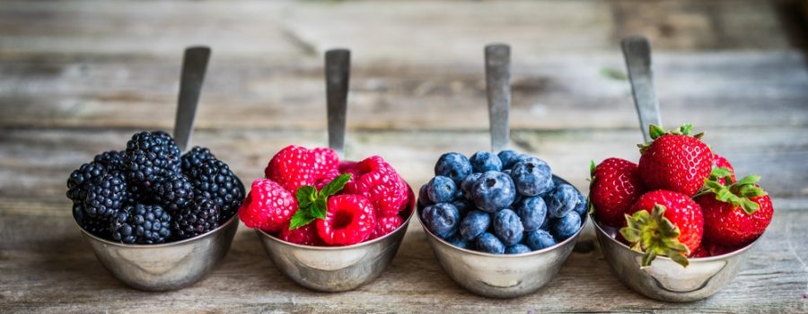 Mix of fresh berries on rustic background